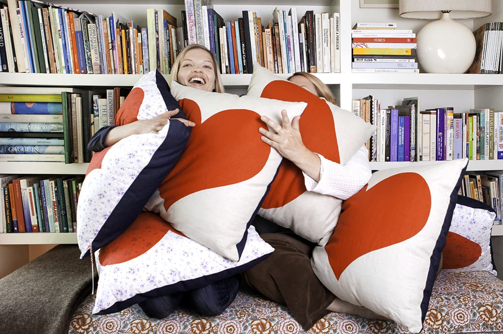 Two people with heart pillows